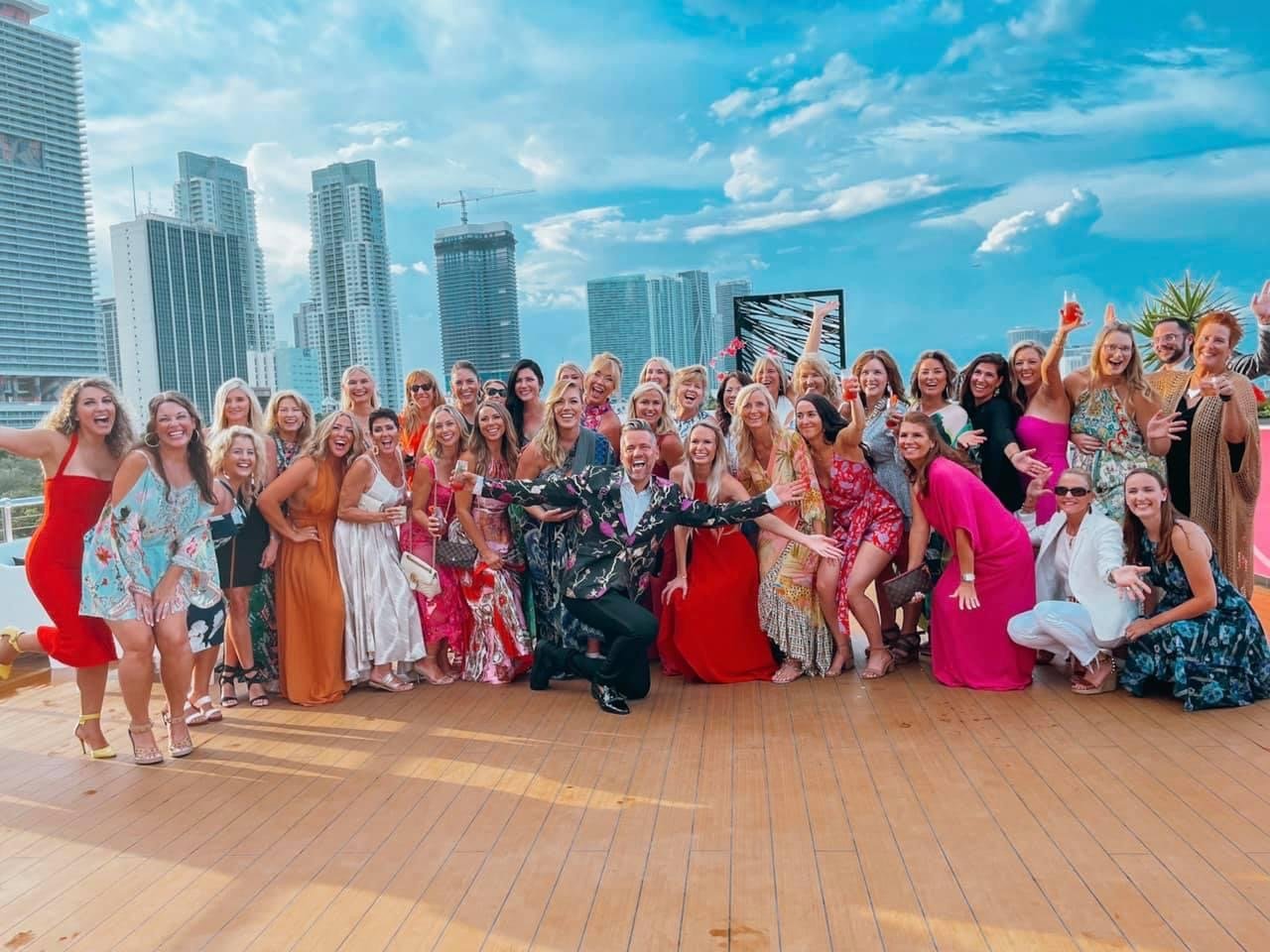 Team posing on a Miami rooftop with skyline